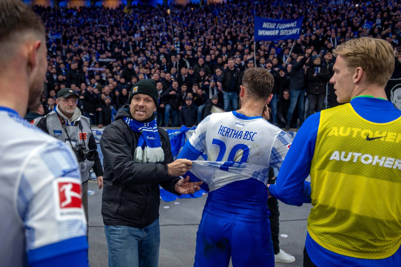 Hertha-Anhänger fordern Fans auf, ihre Trikots auszuziehen.