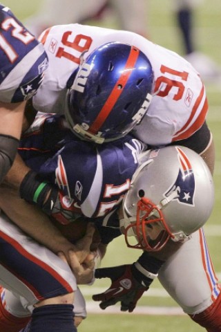 New York Giants defensive end Justin Tuck (91) sacks New England Patriots quarterback Tom Brady during the second half of the NFL Super Bowl XLVI football game, Sunday, Feb. 5, 2012, in Indianapolis. (AP Photo/David Duprey)