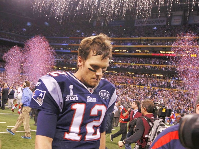 New England Patriots quarterback Tom Brady leaves the field after their loss to the New York Giants in the NFL Super Bowl XLVI football game in Indianapolis, Indiana, February 5, 2012.  REUTERS/Gary Hershorn (UNITED STATES  - Tags: SPORT FOOTBALL)