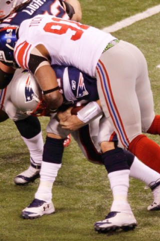 New York Giants defensive end Justin Tuck (91) sacks New England Patriots quarterback Tom Brady during the second half of the NFL Super Bowl XLVI football game, Sunday, Feb. 5, 2012, in Indianapolis. (AP Photo/Charlie Riedel)