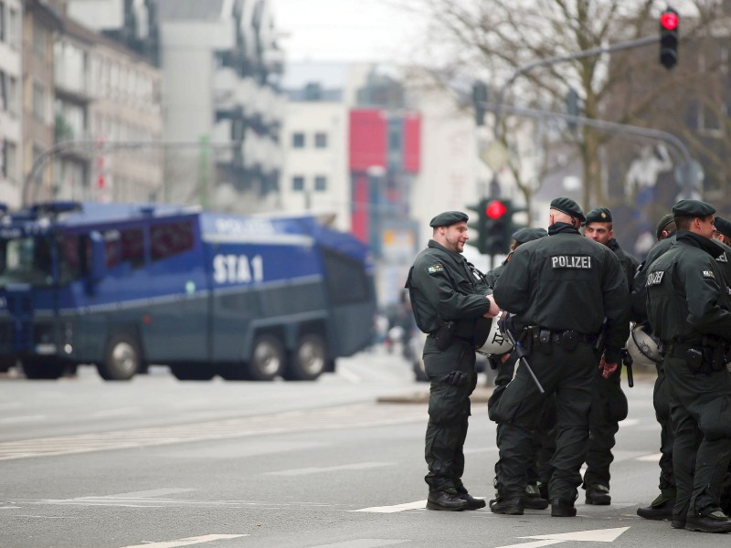 Polizisten und Wasserwerfer stehen in der Stadt.