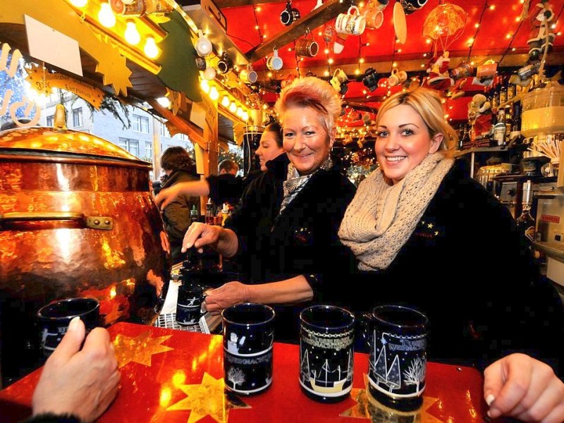 Am Samstag, den 19.11.2011 strömen tausende Besucher am ersten Wochenende auf den Weihnachtsmarkt in Duisburg - Mitte. Bei trockenem kühlen Wetter geniessen die Leute Glühwein , Leckereien oder kaufen schon mal das ein oder andere Geschenk für Weihnachten. Im Foto : Das Glühweingeschäft läuft Foto: Stephan Eickershoff / WAZ FotoPool