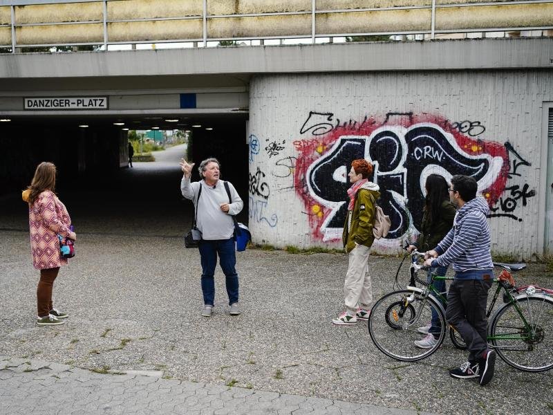 Helmut van der Buchholz, Stadtführer der "Germany‘s Ugliest City Tours", spricht während einer Stadtführung durch die Innenstadt mit Teilnehmern.