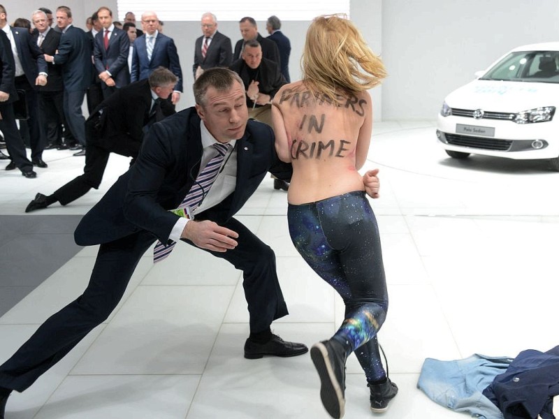 Schreckmoment beim Rundgang von Merkel und Putin auf der Hannover-Messe. Der Nackt-Protest von Femen-Aktivistinnen sorgte kurzzeitig für Aufregung.